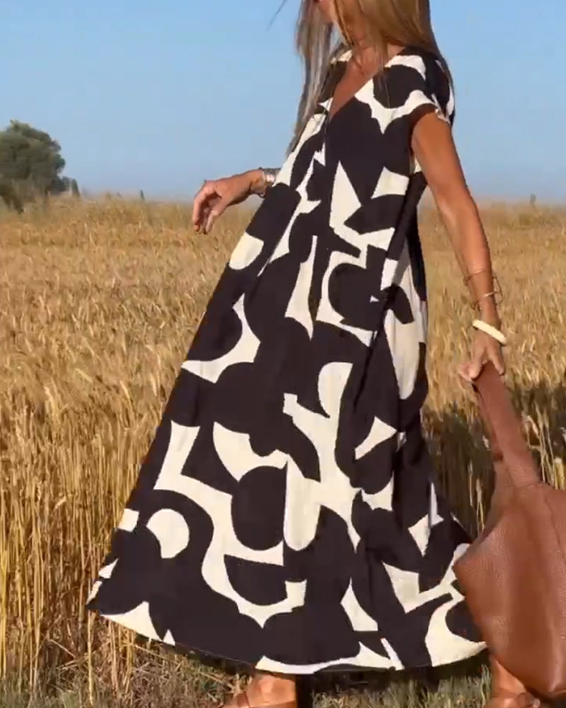 NAOMI | Lange Geprinte Jurk met V-hals en Uitlopende Pasvorm voor een Vakantielook